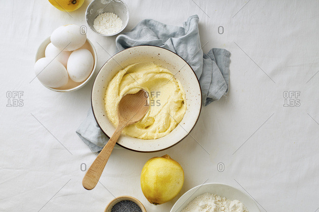 Mixing butter and sugar with wooden spoon while cooking lemon cake