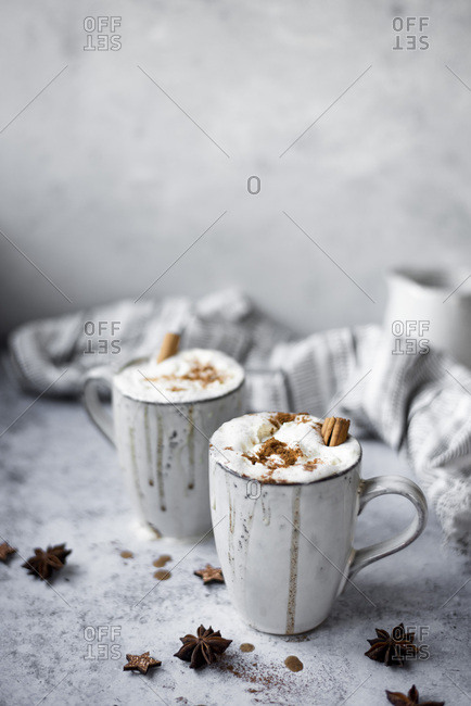 Pumpkin Spiced Latte With Whipped Cream Topping And Cinnamon Dusting Surrounded By Leaves And Spices