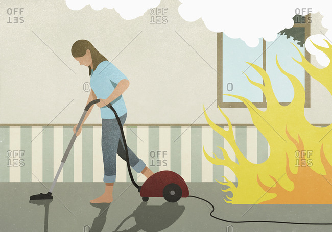 Flames and smoke behind oblivious woman vacuuming carpet