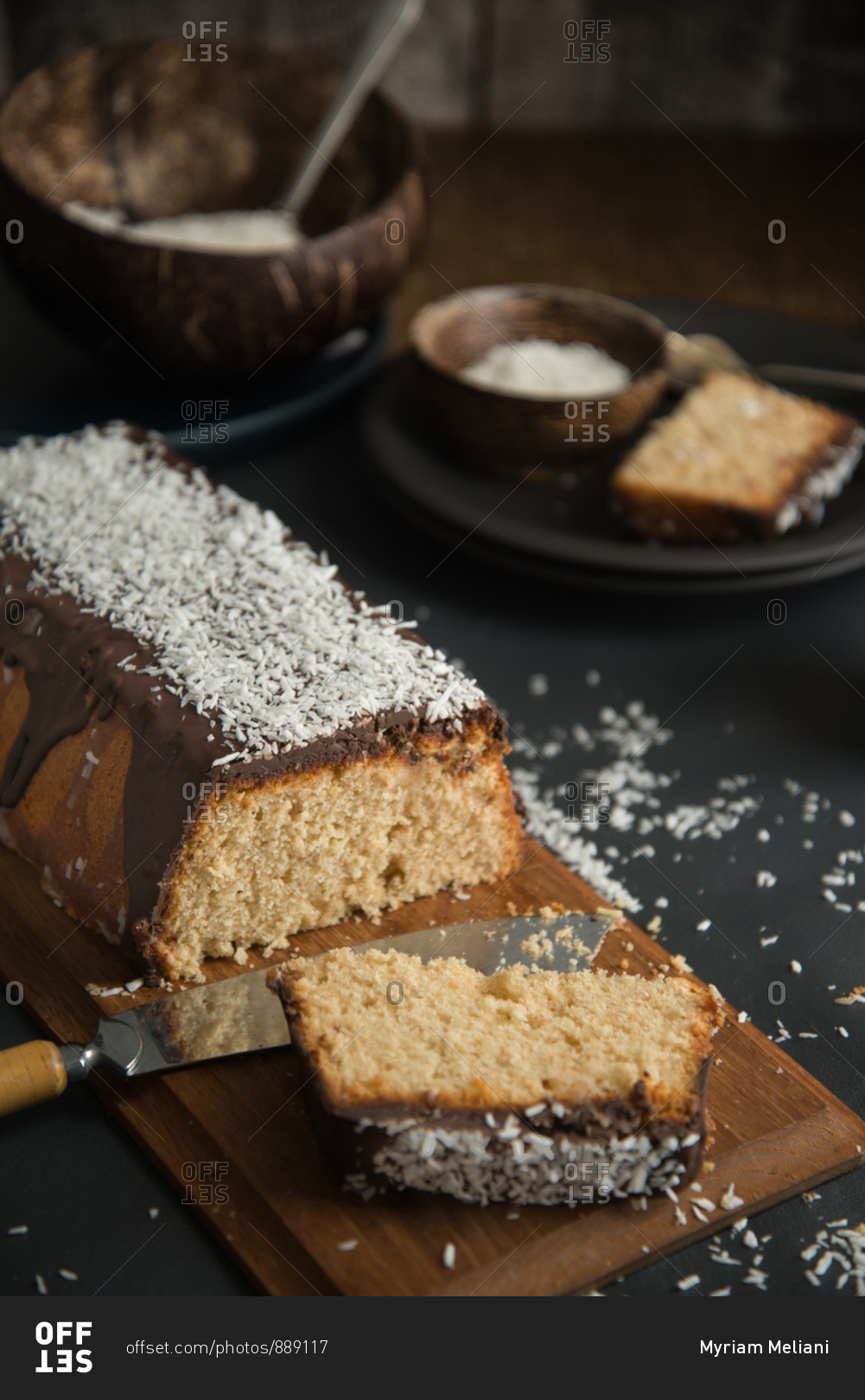 Coconut pound cake glazed with chocolate and coconut rasp, ready to be shared