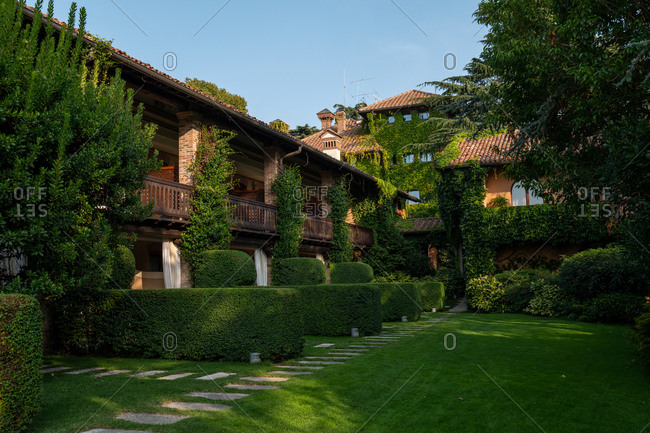 Franciacorta, Italy - September 15, 2019: Exterior of a large villa surrounded by lush green foliage