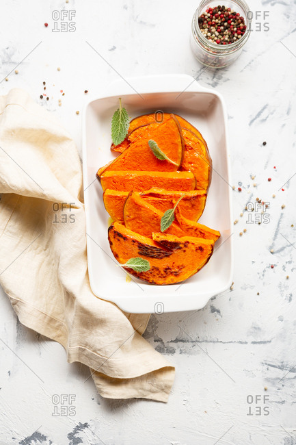 Baked pumpkin slices in a baking dish