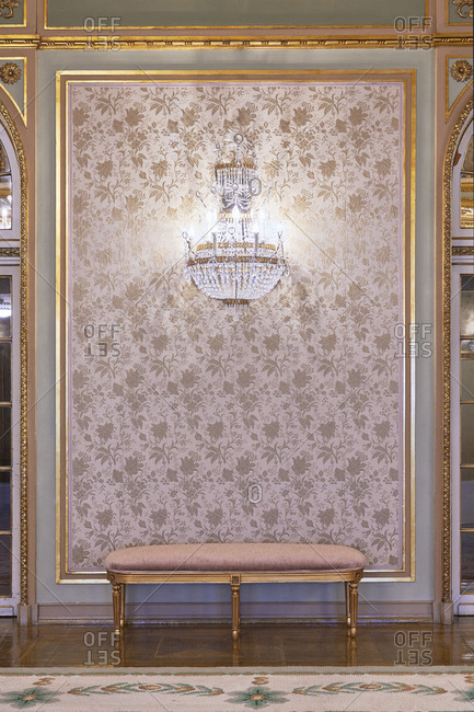 Ornate glass wall sconce on wall in a fancy room, Lisbon, Portugal