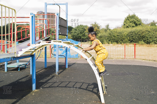 Girl climbing up a ladder on a playground