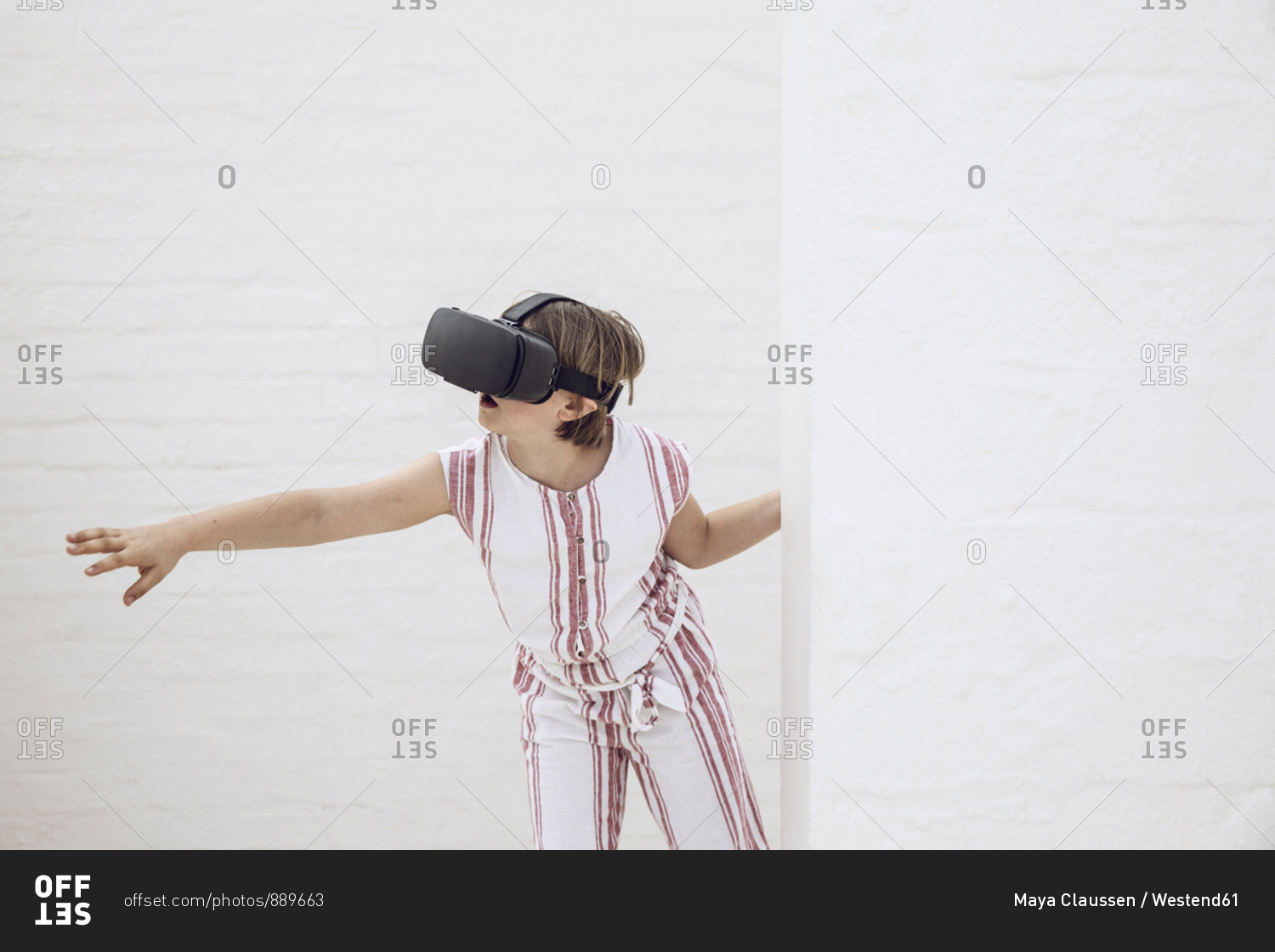 Little girl discovering empty space with VR goggles