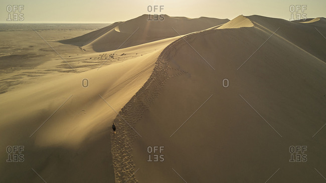 Woman in dune landscape- Namib Desert- Namibia