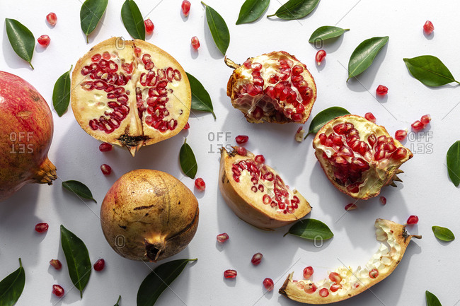 Fresh seasonal pomegranate from above on white background. Healthy food Detox. Flat lay