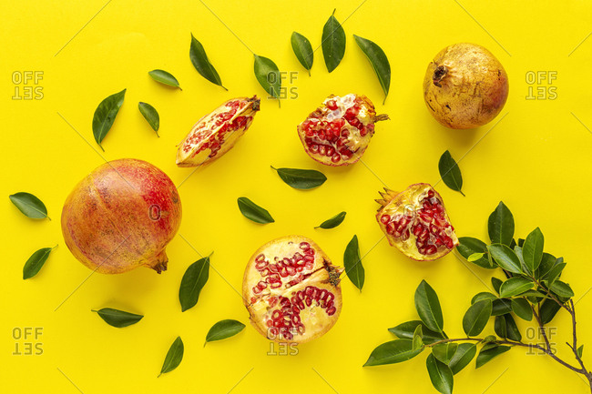 Fresh seasonal pomegranate from above on yellow background. Healthy food Detox. Flat lay