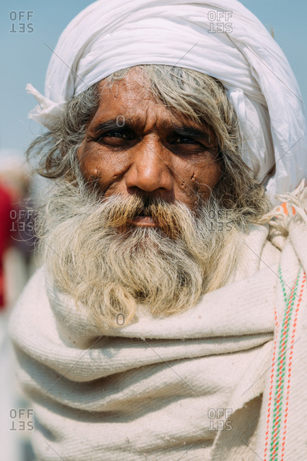 Allahabad, India - FEBRUARY, 2018: Close-up portrait of Elderly Indian man wearing traditional clothes against blurry background