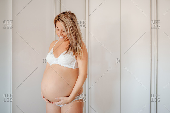 Woman In White Bra Looking On Her Armpit Stock Photo, Picture and Royalty  Free Image. Image 36828402.