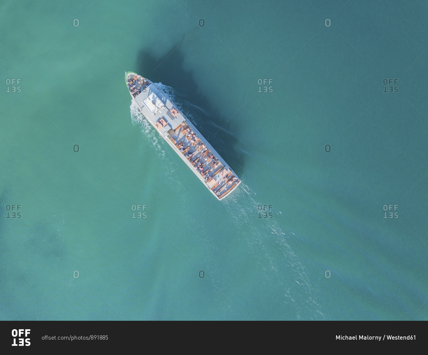 Germany- Bavaria- Aerial view of tour boat sailing across turquoise waters of Chiemsee lake