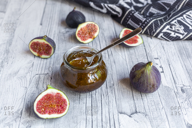 Sliced figs and jar of homemade fig jam