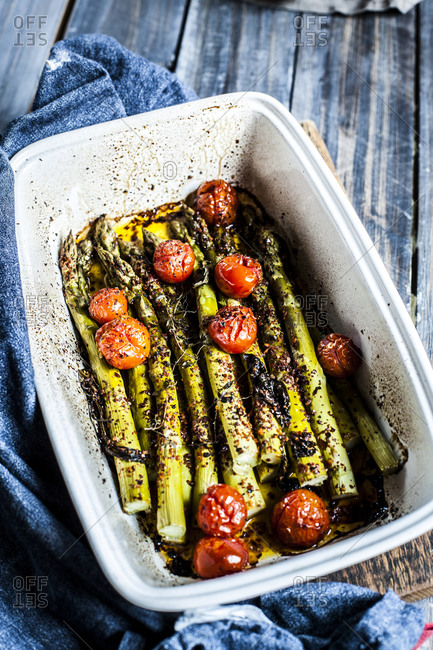 Grilled green asparagus with cherry tomatoes in a casserole