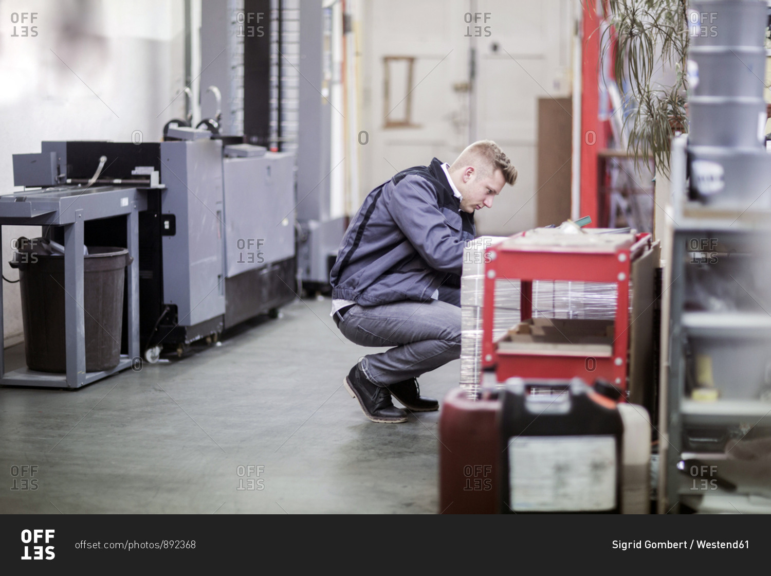 Young man working in a printing company
