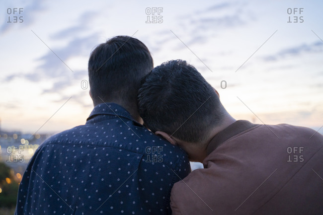 Rear view of gay couple on lookout above the city- Barcelona- Spain