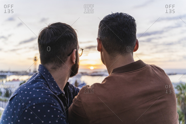 Rear view of gay couple on lookout above the city- Barcelona- Spain