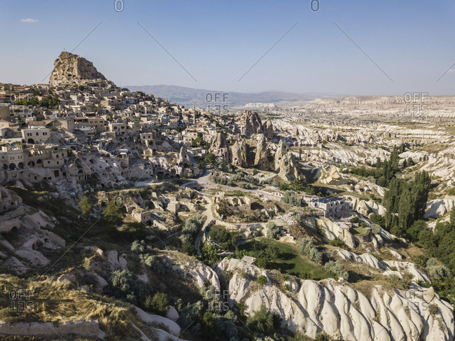 Aerial view of Uchisar castle and buildings against blue sky in Cappadocia- Turkey