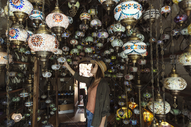 Side view of young woman choosing lanterns in store- Cappadocia- Turkey