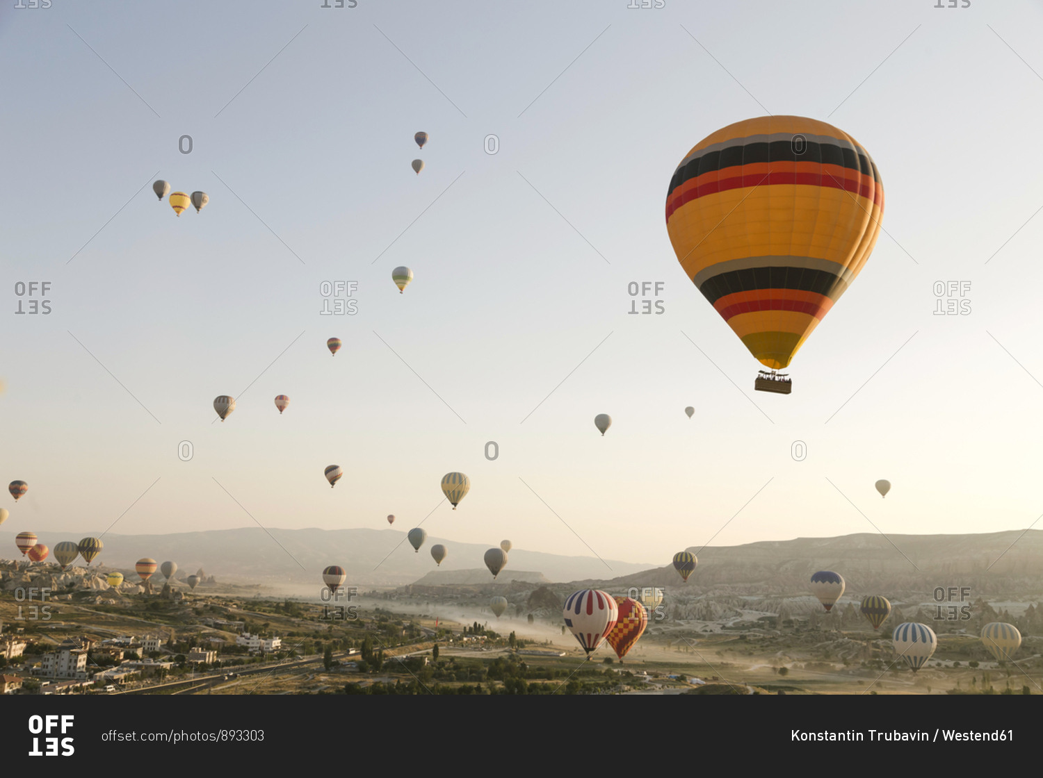 Colorful hot air balloons flying over land at Goreme National Park- Cappadocia- Turkey