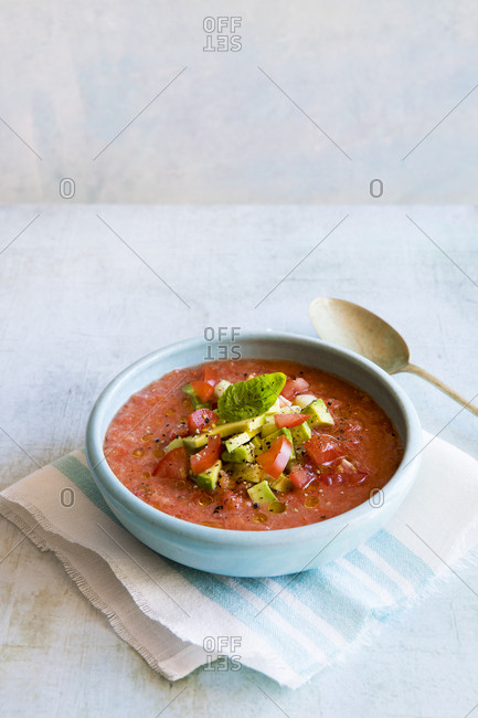 Bowl of gazpacho with avocado and strawberry