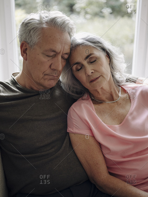 Senior couple napping on couch at home