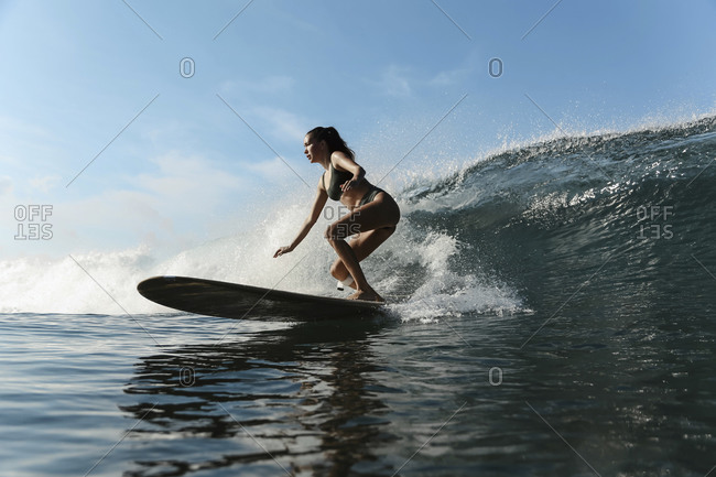 Girl surfing in ocean