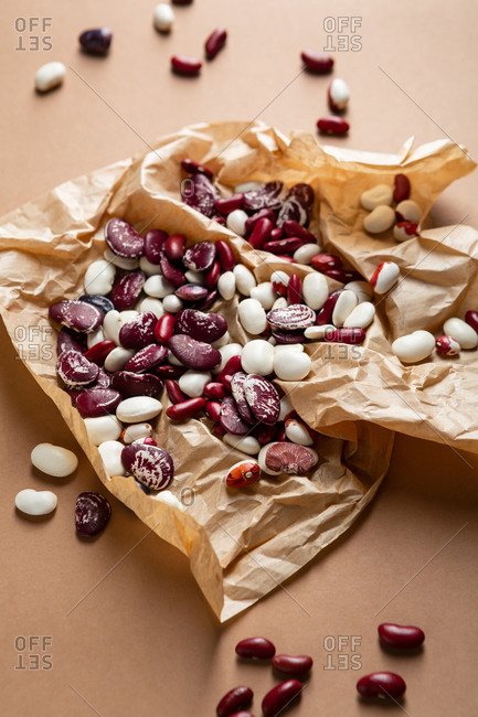 Variety of beans on brown wrinkled paper