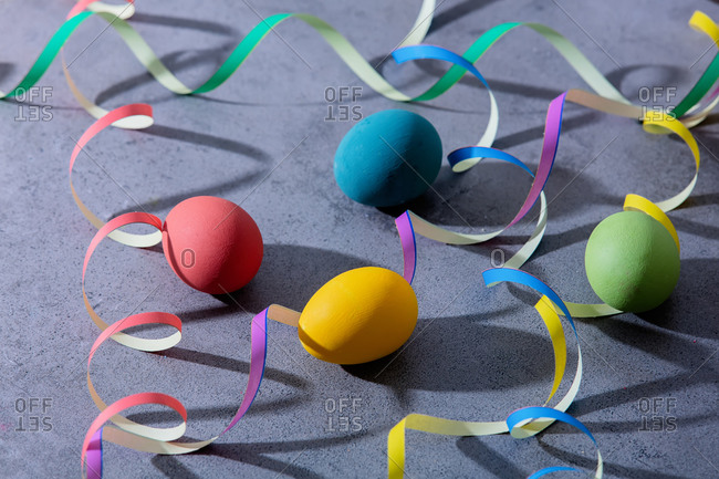 Colored easter eggs and serpentine on concrete background