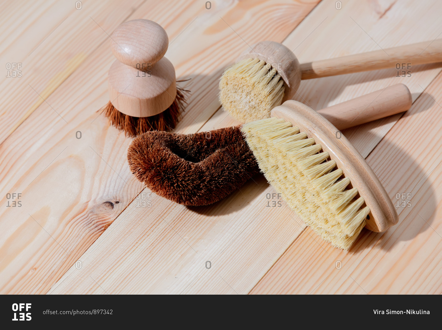 Eco-friendly wooden brushes for washing dishes on a wooden table