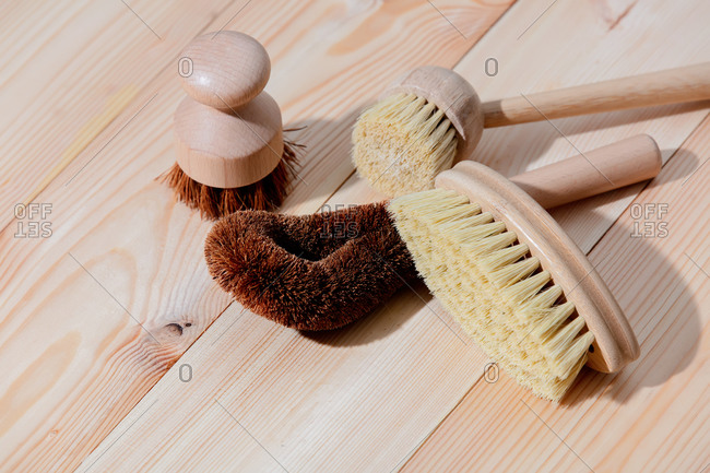 Eco-friendly wooden brushes for washing dishes on a wooden table