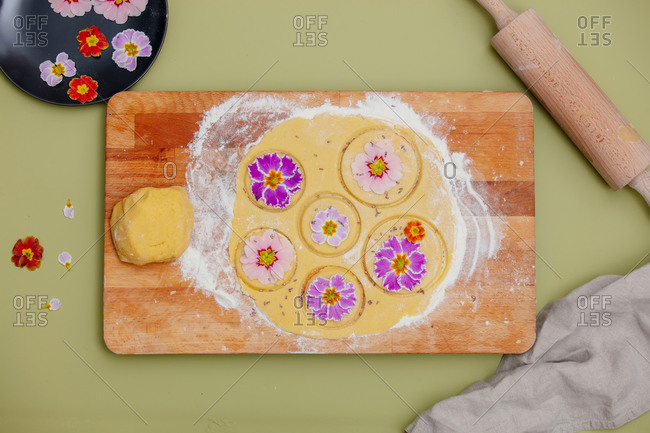 Dough with petals of a primula flower for a cookies