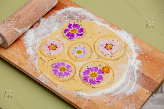 Dough with petals of a primula flower for a cookies