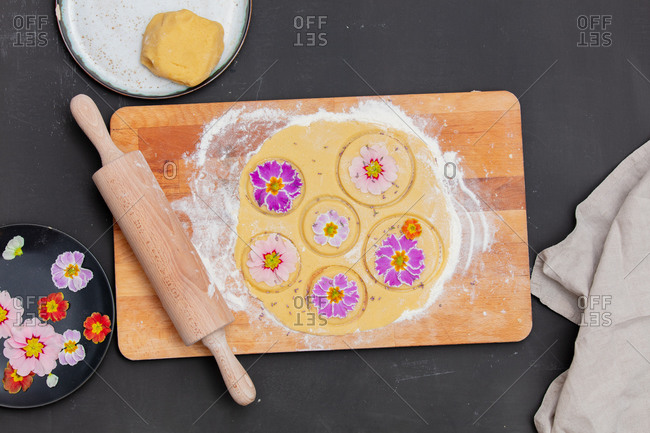 Dough with petals of a primula flower for a cookies