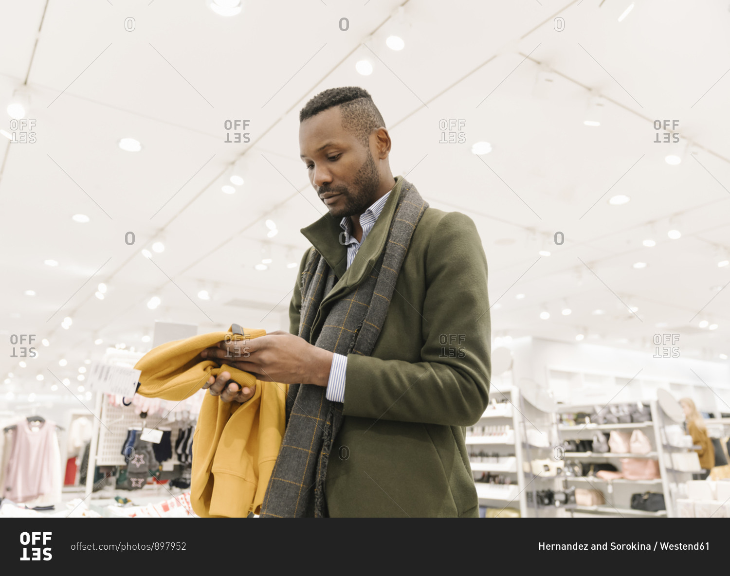 Stylish man shopping in a clothes store stock photo