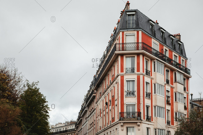 From below of colorful building in Paris, france on cloudy day