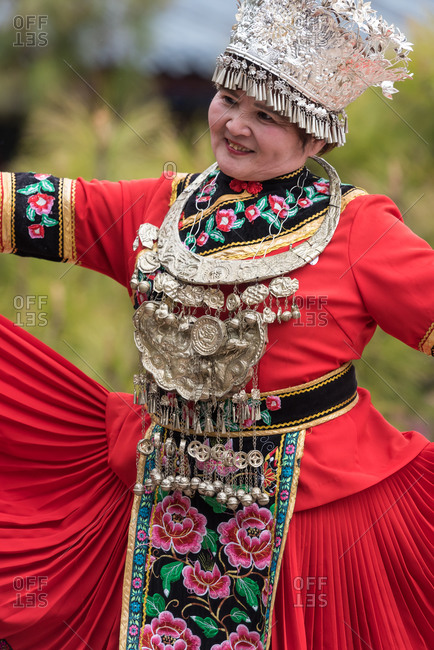 March, 16. 2019: Woman wearing costume of a Yunnan Minority. Lijiang, Yunnan Province, China.