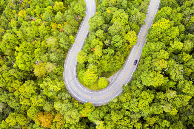 A car drives around a hairpin turn on Route 17 and the Appalachian Gap in Buels Gore, Vermont