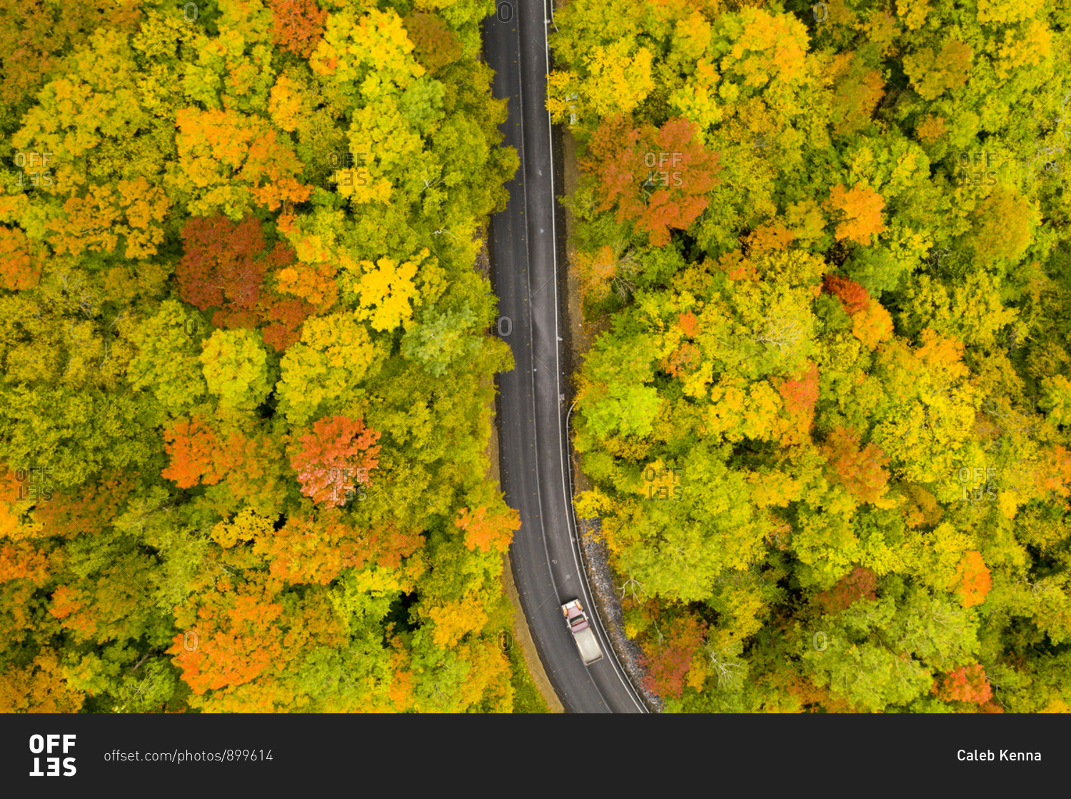 Drone view over highway leading through autumn forest in Brandon Gap in Goshen, Vermont