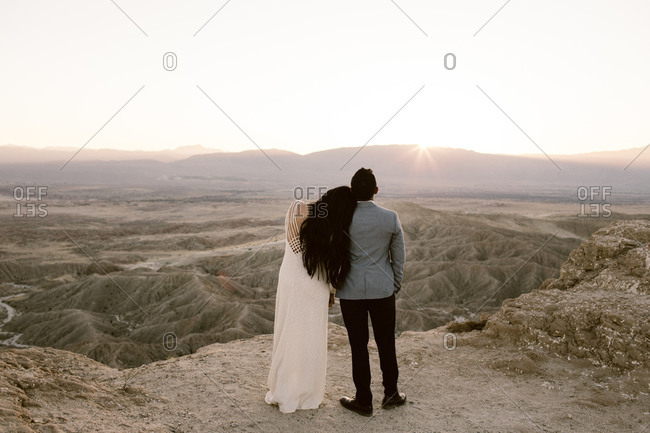 Rear view of couple watching sunset over desert vista