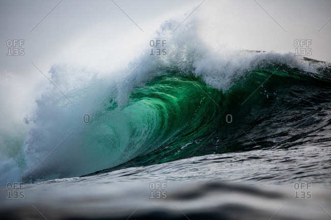 Large turquoise wave in the ocean