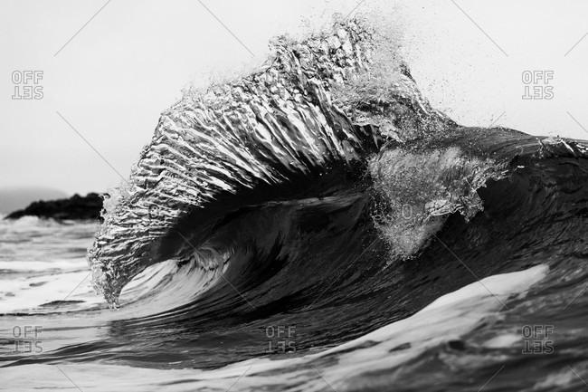 Splashing waves on the coast of Tofino in black and white