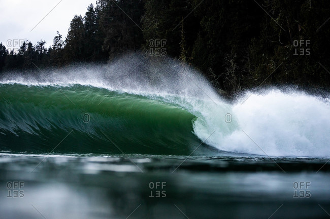 Splashing turquoise wave off the coast of Tofino, Vancouver, British Columbia