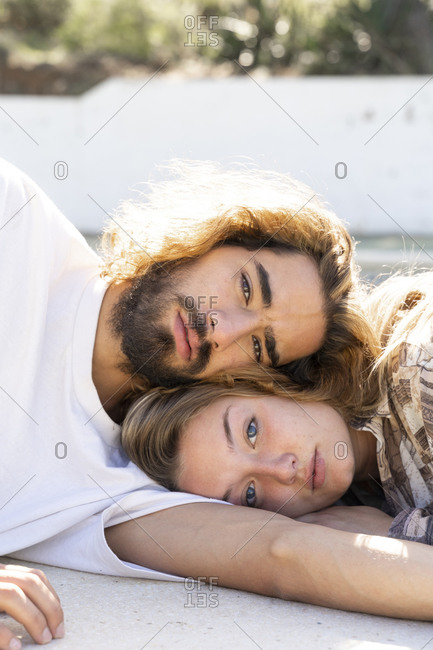Portrait of young couple head to head outdoors