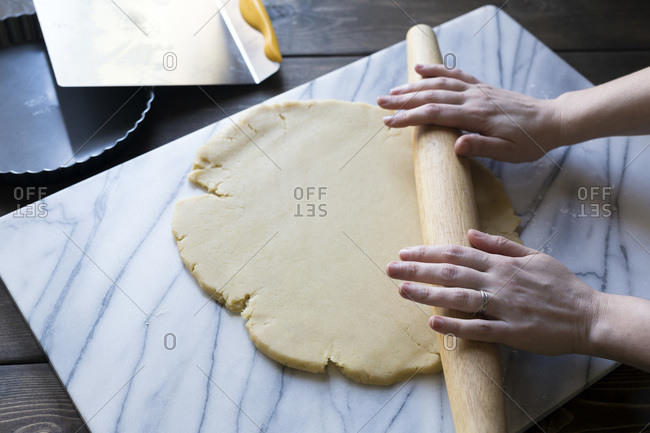 Step-by-step photo for rolling tart dough into a tart pan.