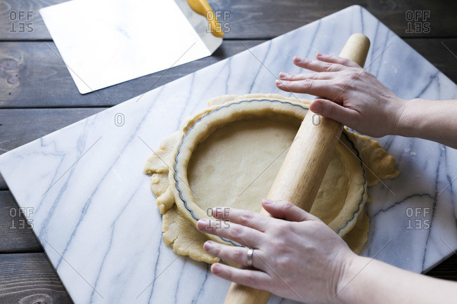 Step-by-step photo for rolling tart dough into a tart pan.