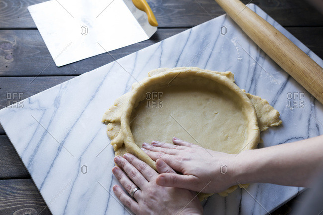 Step-by-step photo for rolling tart dough into a tart pan.