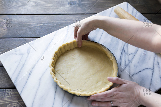 Step-by-step photo for rolling tart dough into a tart pan.