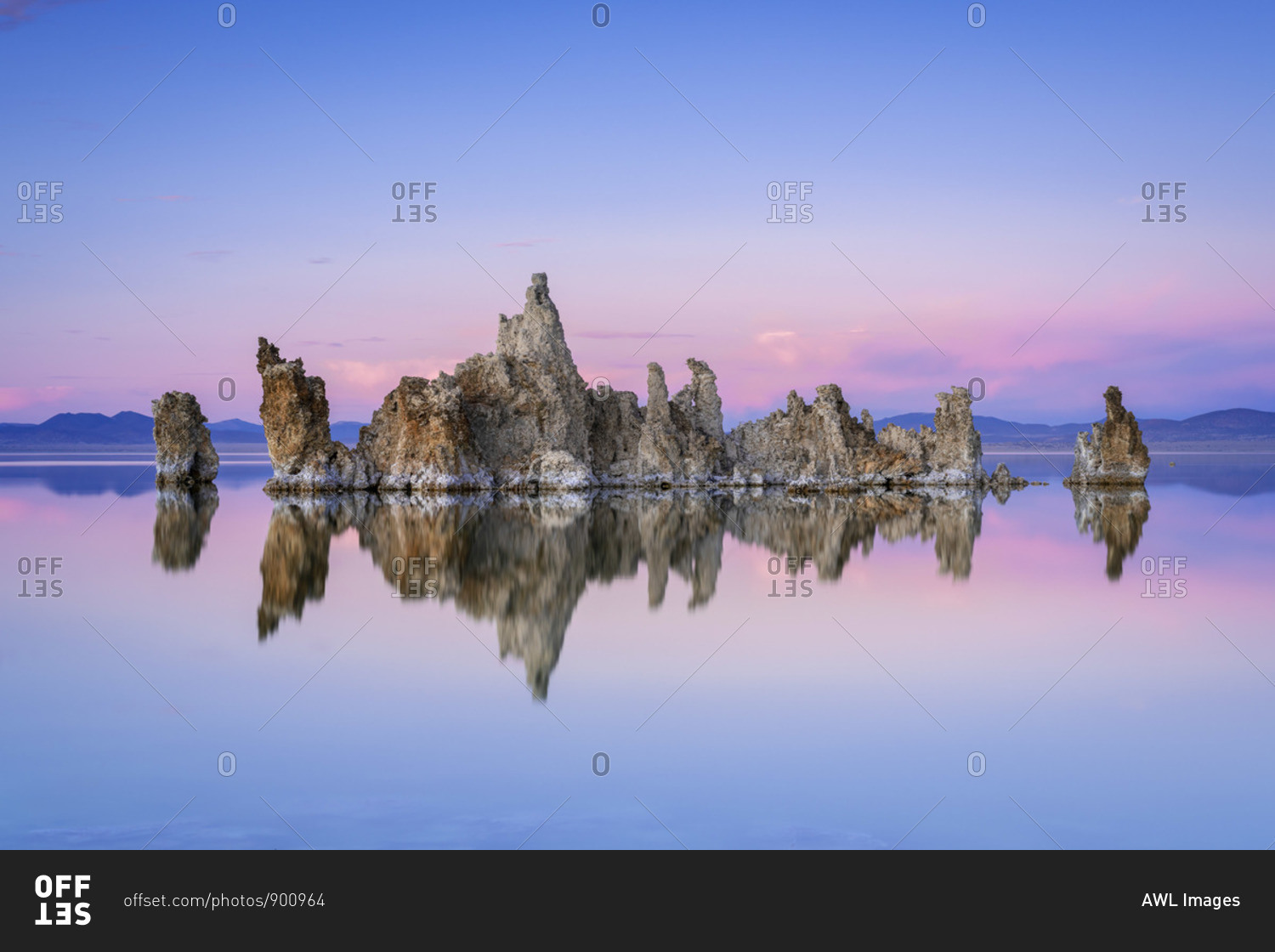 Reflection of rock formation in South Tufa on Mono Lake against blue sky at sunset, Mono County, Sierra Nevada, Eastern California, California, USA