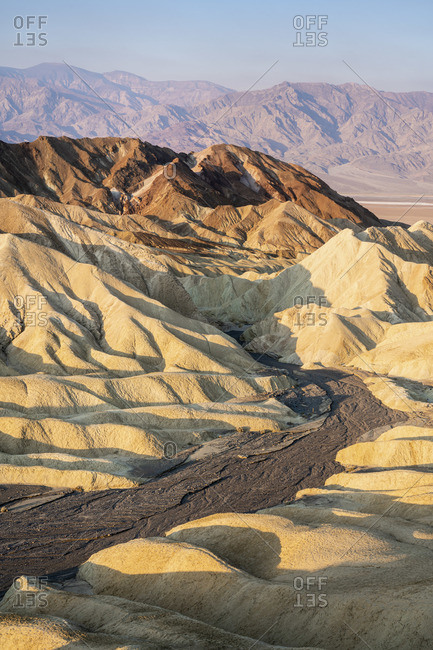 Scenic view of natural rock formations at Zabriskie Point during sunrise, Death Valley National Park, Eastern California, California, USA