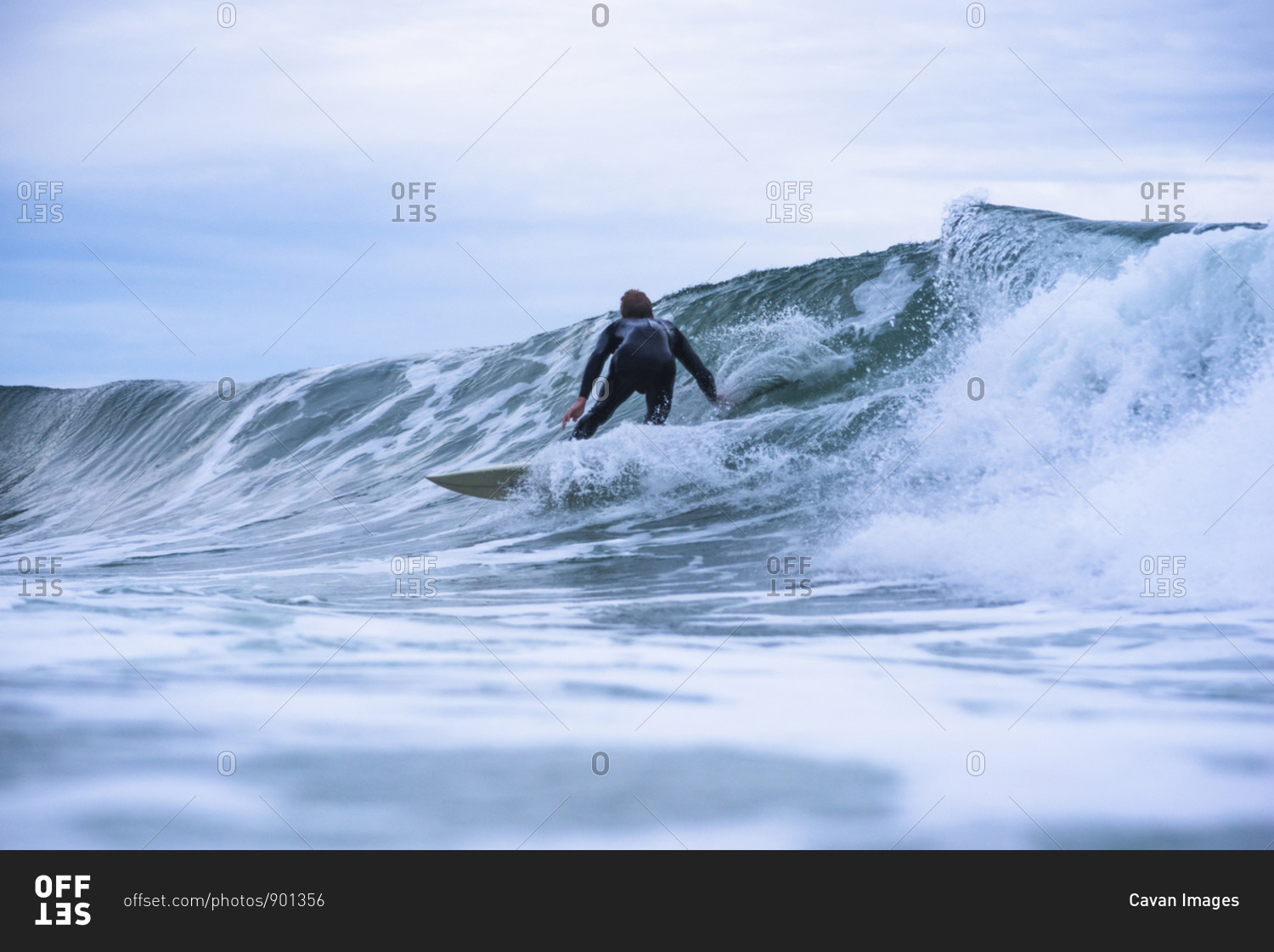 Young man surfing on overcast day